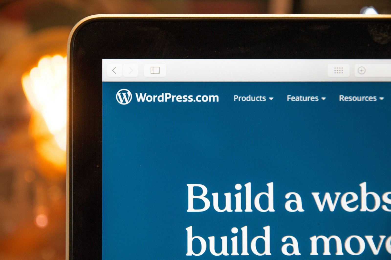 turned-on monitor of a laptop displaying wordpress.com on the top right of the screen